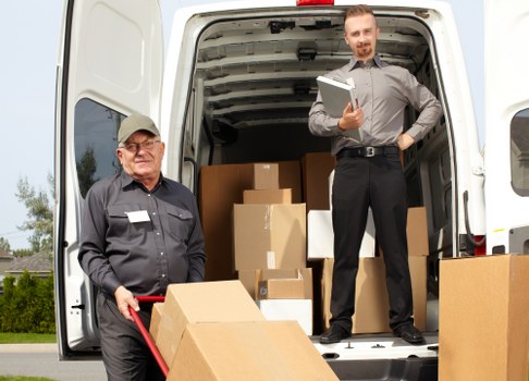Furniture pick-up service removing a sofa in Norwood