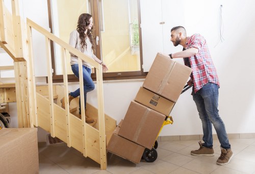 Careful packing of fragile items for a student move in Norwood
